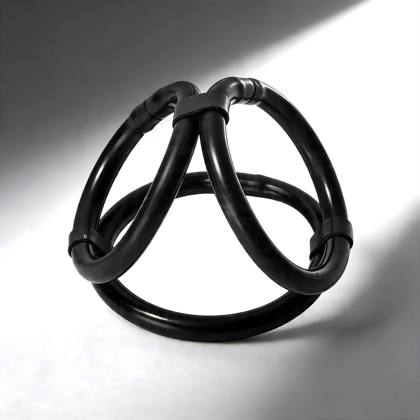flexible black tri cock ring with easy release design and three interconnected loops for custom fit