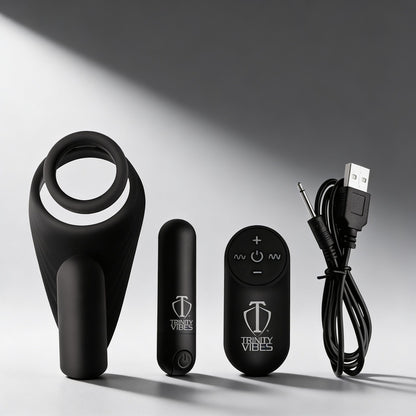 black silicone vibrating cock ring with curved taint stimulator shown with bullet vibrator remote control and USB charging cable on gray background