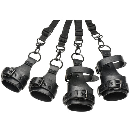 Set of black leather restraints with straps on a white background
