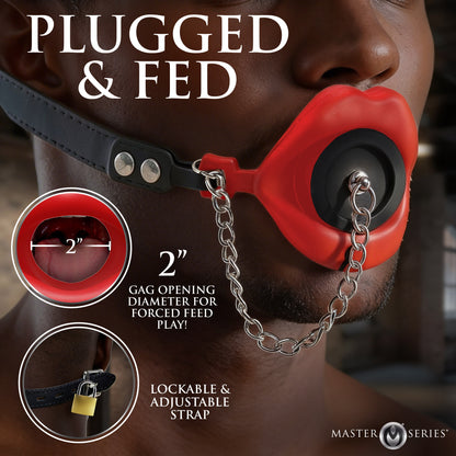 Red feeding gag sealed with black plug for muffled male mouth restraint during
bondage scenes 