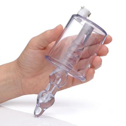 Transparent anal pump cylinder with textured stimulator shaft held in one hand to demonstrate the product's size and ergonomic design.