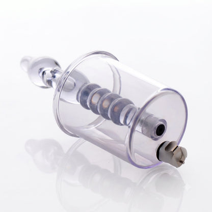 Rear angled view of a transparent anal pump cylinder highlighting the vacuum port, air-release valve, and internal textured stimulation shaft.