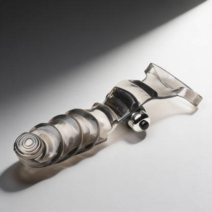 Smoke-colored vibrating finger glove with textured ridges, curved insertable tip, and attached bullet vibrator displayed at an angled view on a light surface.