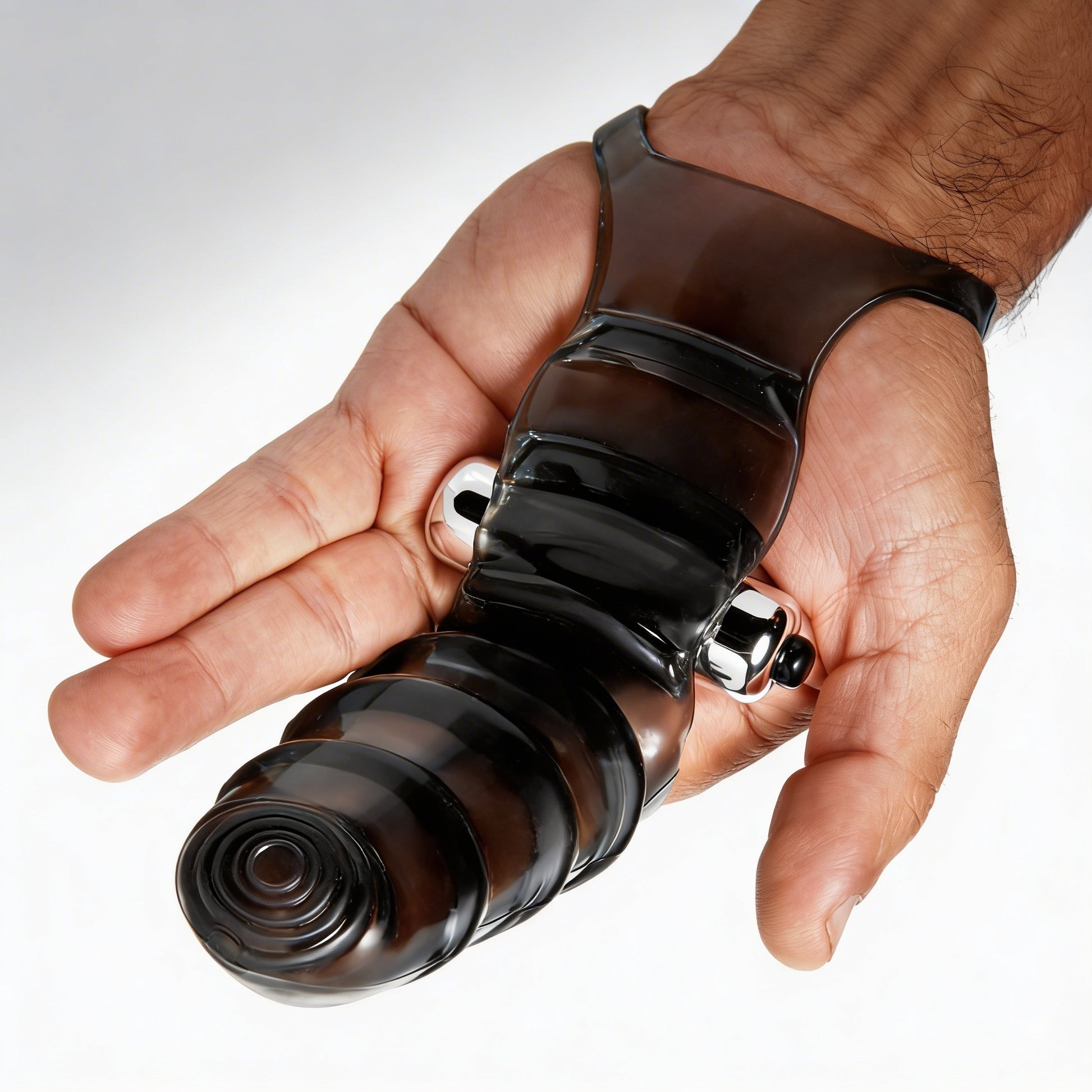 Vibrating finger glove worn on a hand, demonstrating the secure finger-mounted design, textured stimulation sleeve, and attached bullet vibrator.