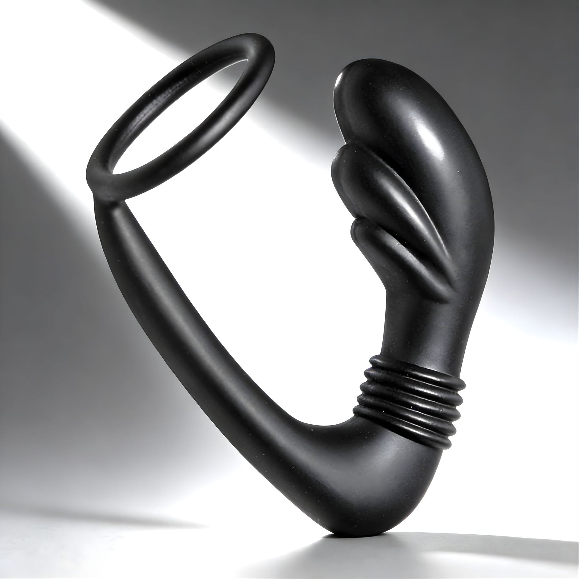 black silicone prostate massager with cock ring featuring curved shaft and flexible ring on clean background