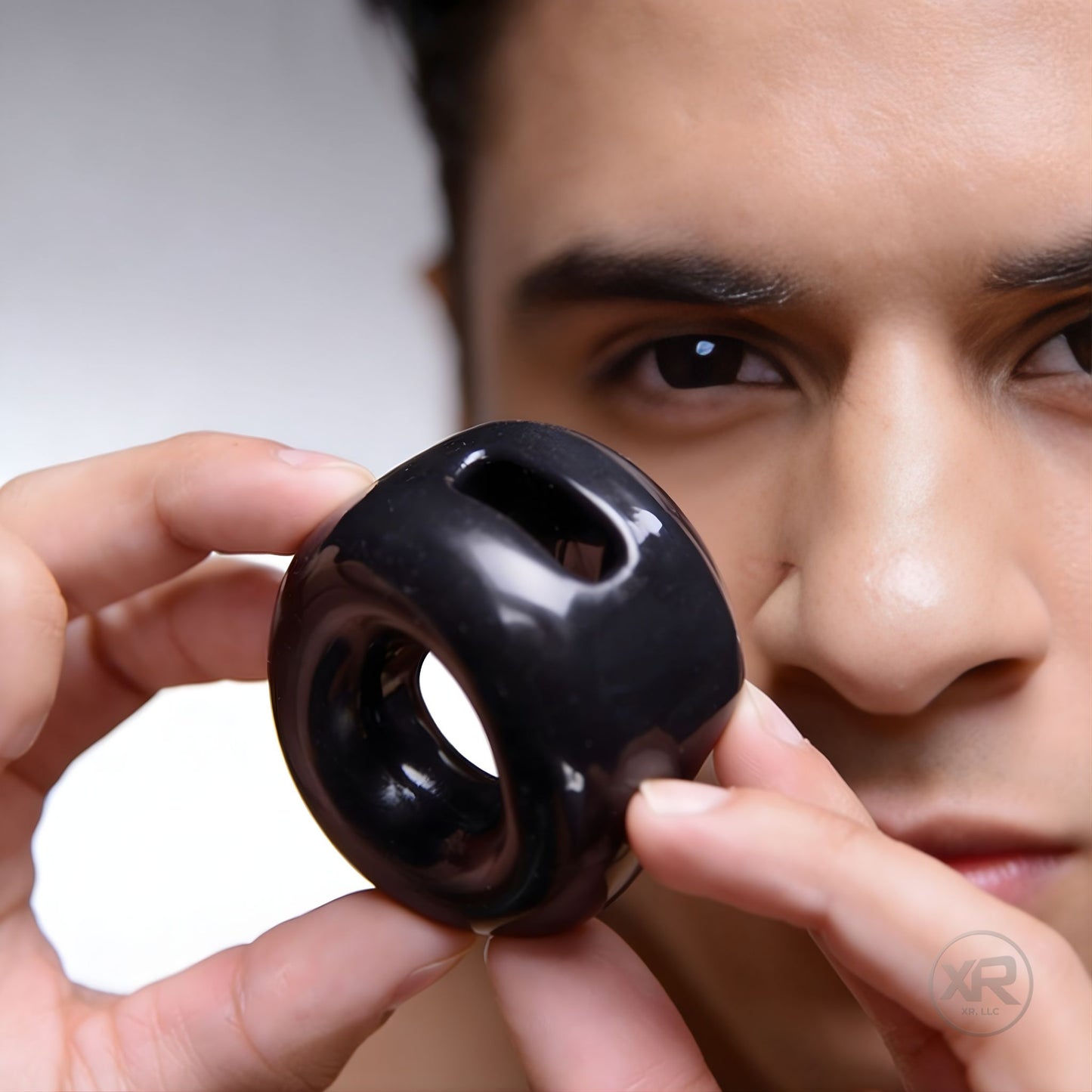 cock holster cock and ball ring for gay men shown in hand highlighting contoured shape and snug supportive fit