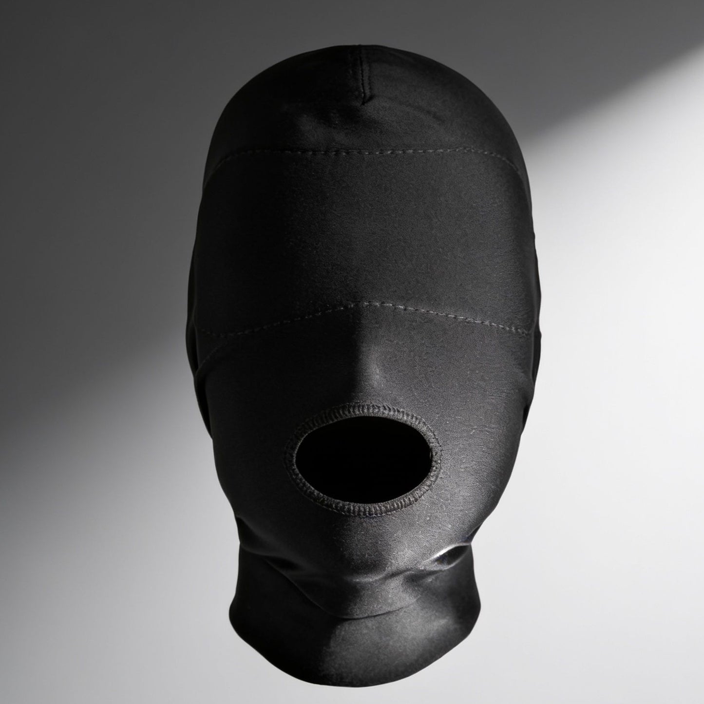 front view of black open mouth hood featuring a padded blindfold panel that completely blocks vision while leaving the mouth exposed