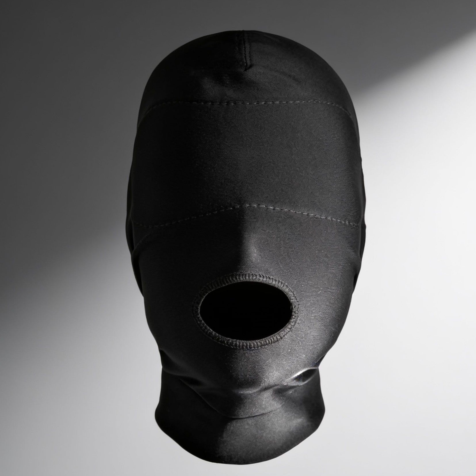 front view of black open mouth hood featuring a padded blindfold panel that completely blocks vision while leaving the mouth exposed