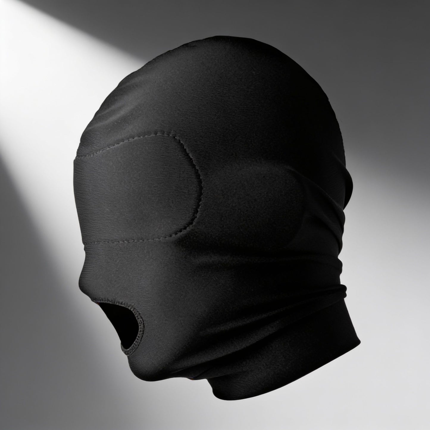 black stretch hood with open mouth design and integrated padded blindfold shown in side profile with full head coverage