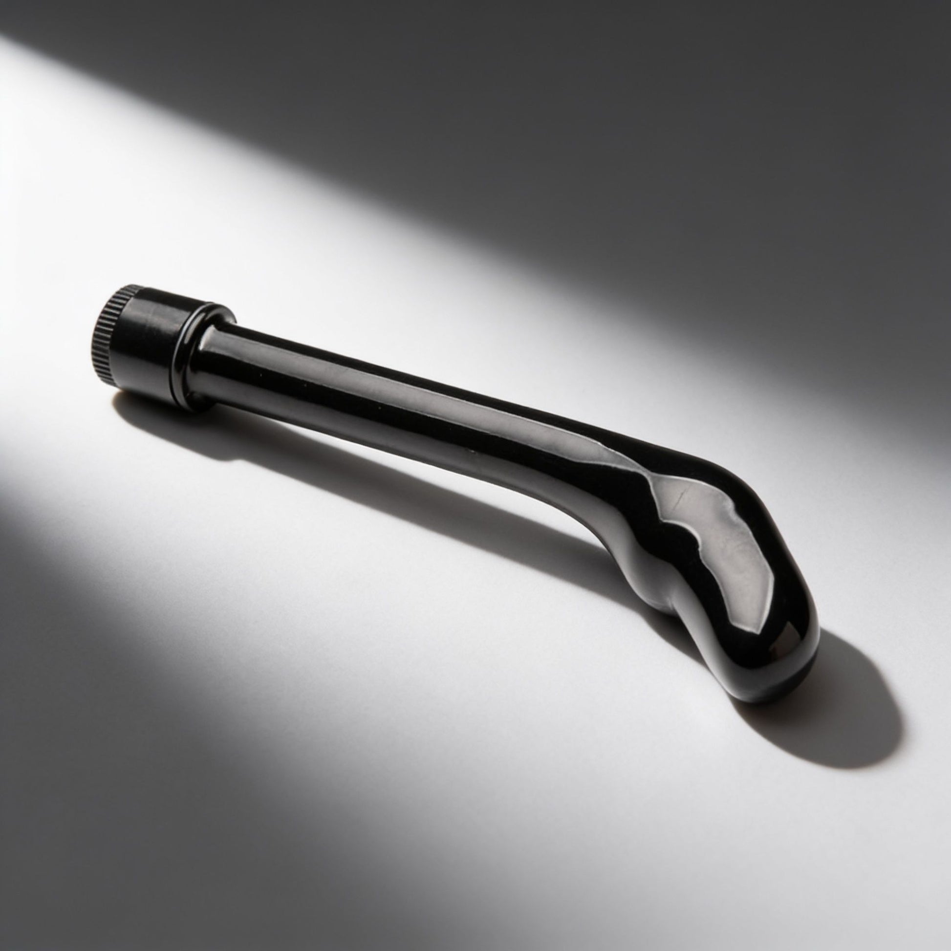 black curved prostate vibrator with a bulbous angled tip and control dial base displayed on a light background, highlighting its streamlined design