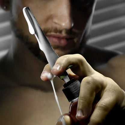Artillery Flex Shooter lube applicator pumping a stream of lube from a bottle, Fort Troff gay gear at Boyzshop