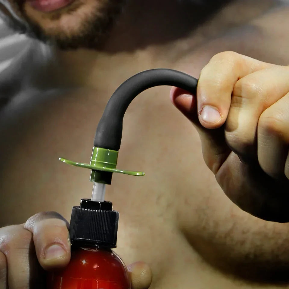 Artillery Flex Shooter flexible silicone nozzle bending in hand on a lube bottle, Fort Troff gay gear at Boyzshop