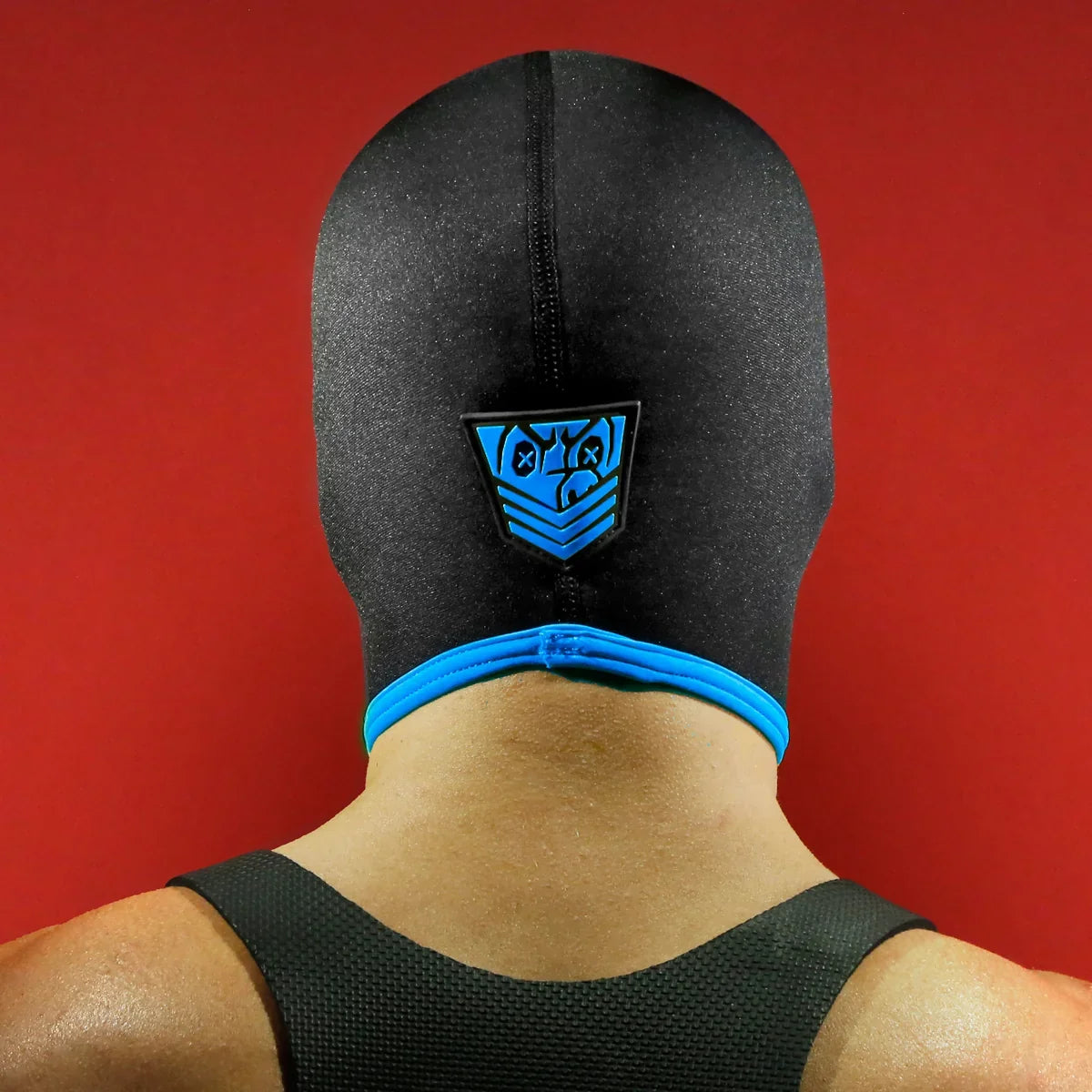 Rear view of the Blind Skullfuck bondage hood showing the blue Fort Troff shield plus neck trim, Fort Troff gay gear at Boyzshop