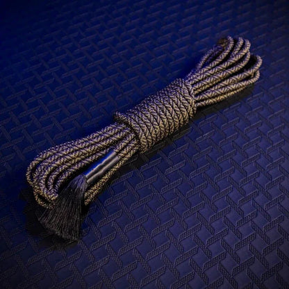Grunt Rope 30 ft olive bondage rope coiled in a hank with a tassel end on a blue backdrop, Fort Troff gay gear at Boyzshop