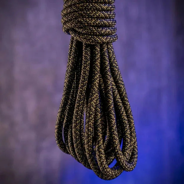 Grunt Rope olive shibari rope hanging in a loose coil against a purple backdrop, Fort Troff gay gear at Boyzshop