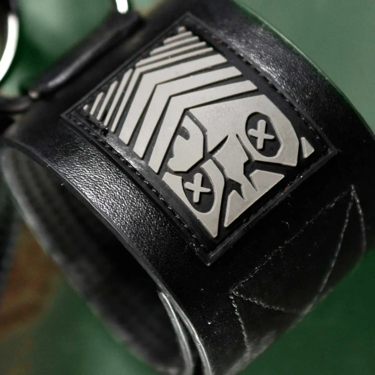 Close-up of the embossed Fort Troff shield patch on a black Neo velcro wrist restraint, Fort Troff gay gear at Boyzshop