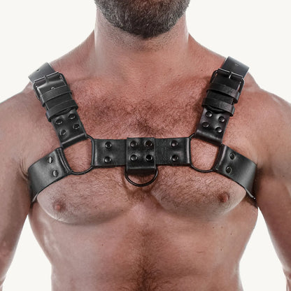 Front view of the black bulldog harness on a bare chest, center D-ring, Fort Troff gay gear at Boyzshop