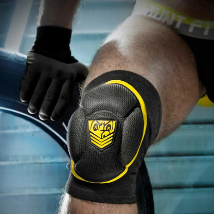 Yellow trim Skullfuck knee pad over a bare knee, yellow Fort Troff shield on the cushion, Fort Troff gay gear at Boyzshop