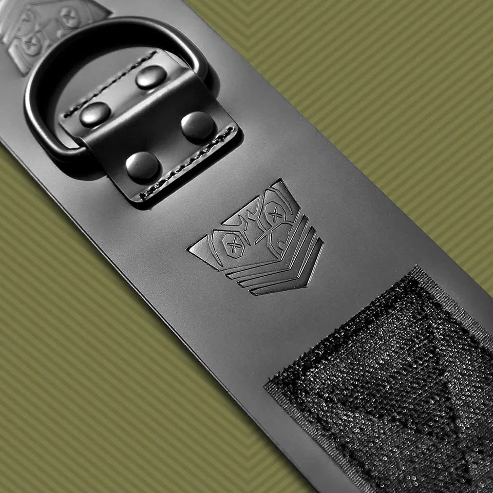 Macro of a leather ankle cuff showing the riveted D-ring, embossed shield, Velcro patch, Fort Troff gay gear at Boyzshop
