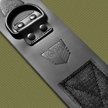 Macro of a leather ankle cuff showing the riveted D-ring, embossed shield, Velcro patch, Fort Troff gay gear at Boyzshop