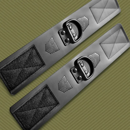Leather ankle cuffs pair laid flat at an angle on olive, Velcro panels at each end, Fort Troff gay gear at Boyzshop
