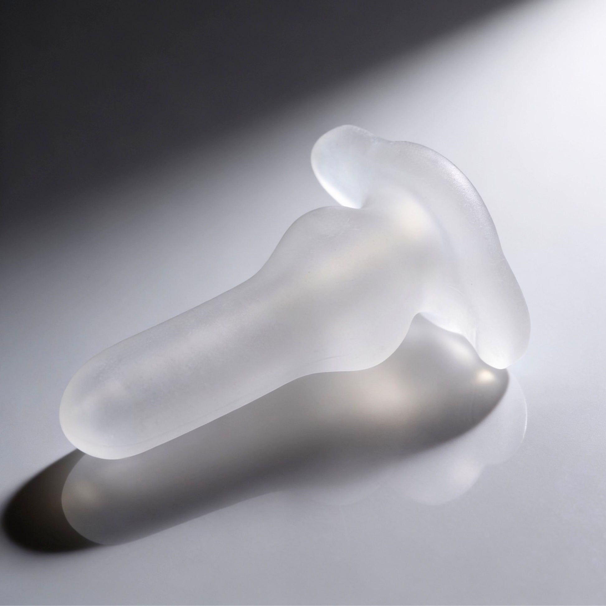 Side profile of the Inception Fuckhole Sheath featuring a smooth tapered shaft, frosted translucent finish, and broad ergonomic flange for stability during use.