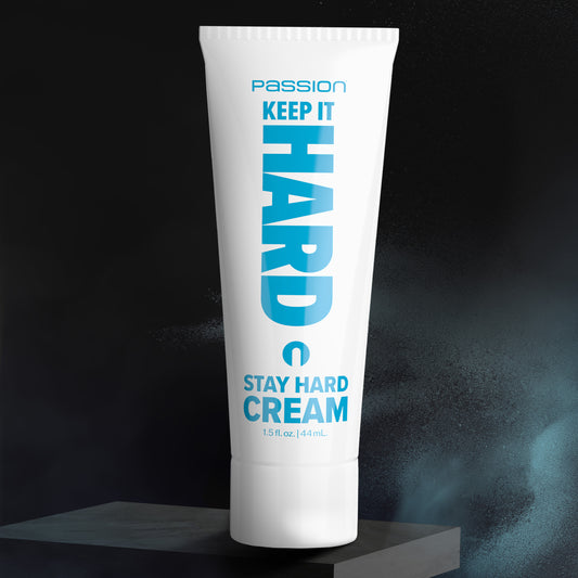 Keep It Hard Stay Hard cream tube standing on dark display platform with dramatic lighting background
