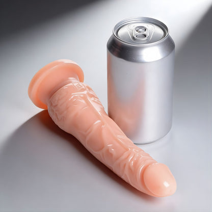 7 inch realistic dildo with suction cup base placed next to soda can for size comparison