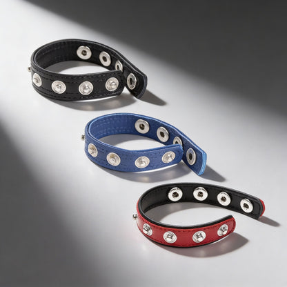 black blue and red leather snap cock rings with silver stud closures displayed on gray background