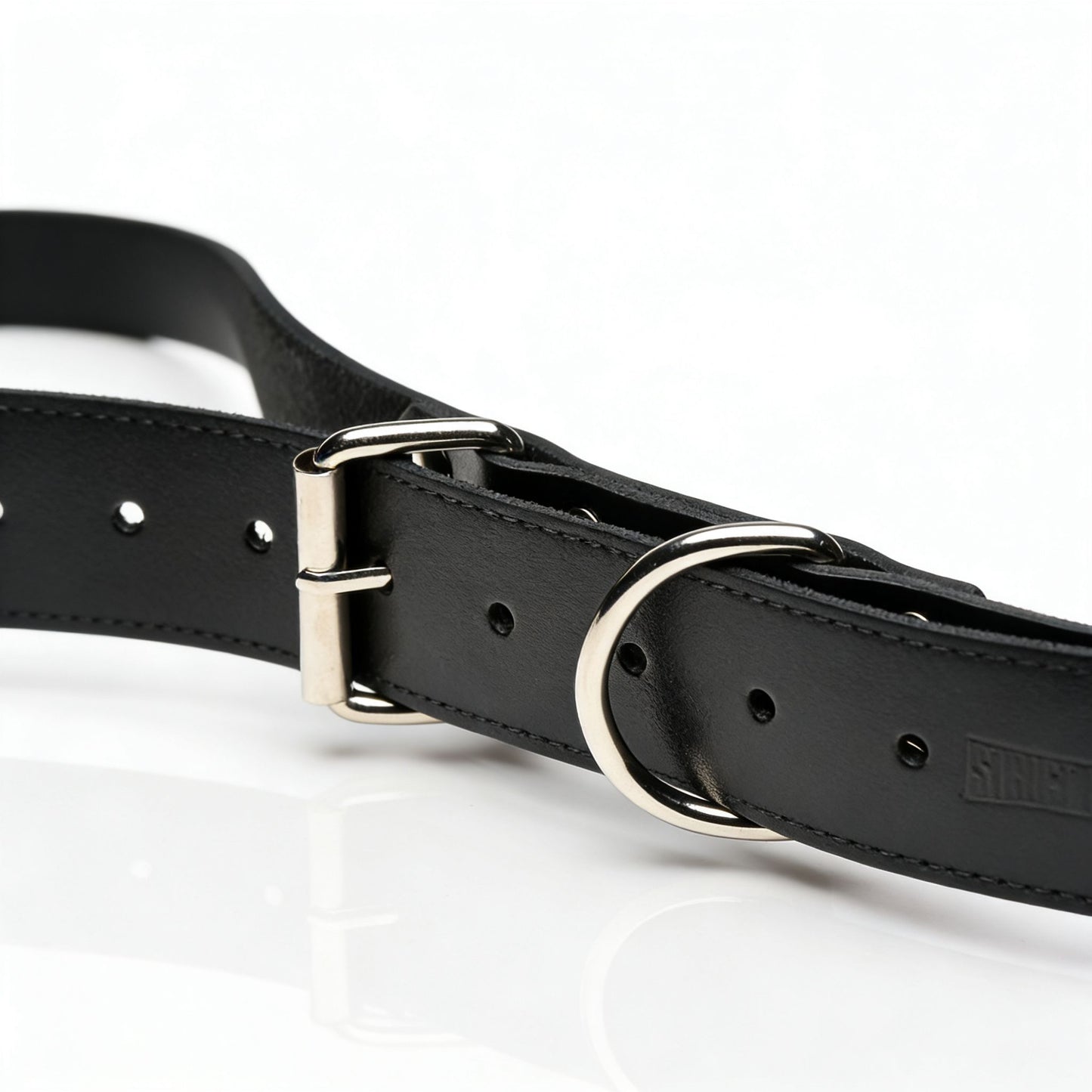 close-up of adjustable black leather thigh sling strap with silver buckle and O-ring hardware detail