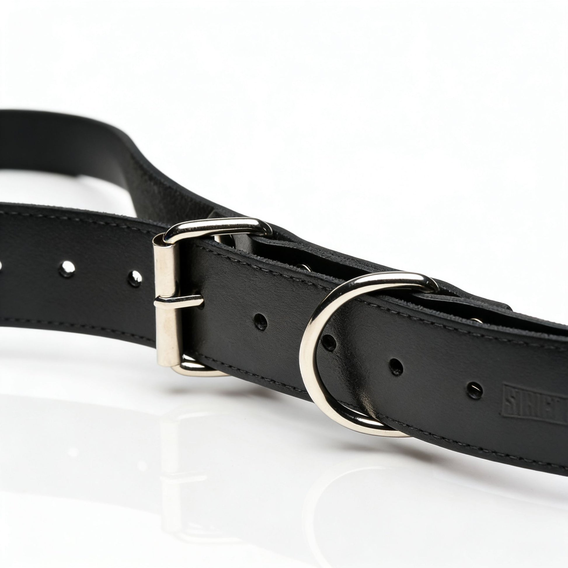 close-up of adjustable black leather thigh sling strap with silver buckle and O-ring hardware detail