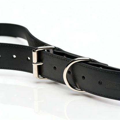close-up of adjustable black leather thigh sling strap with silver buckle and O-ring hardware detail