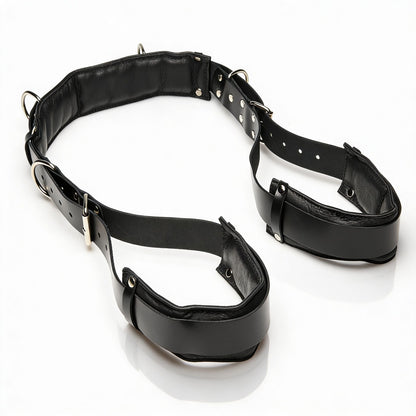 black leather thigh sling restraint system with padded thigh cuffs, adjustable collar, and silver hardware displayed on white background