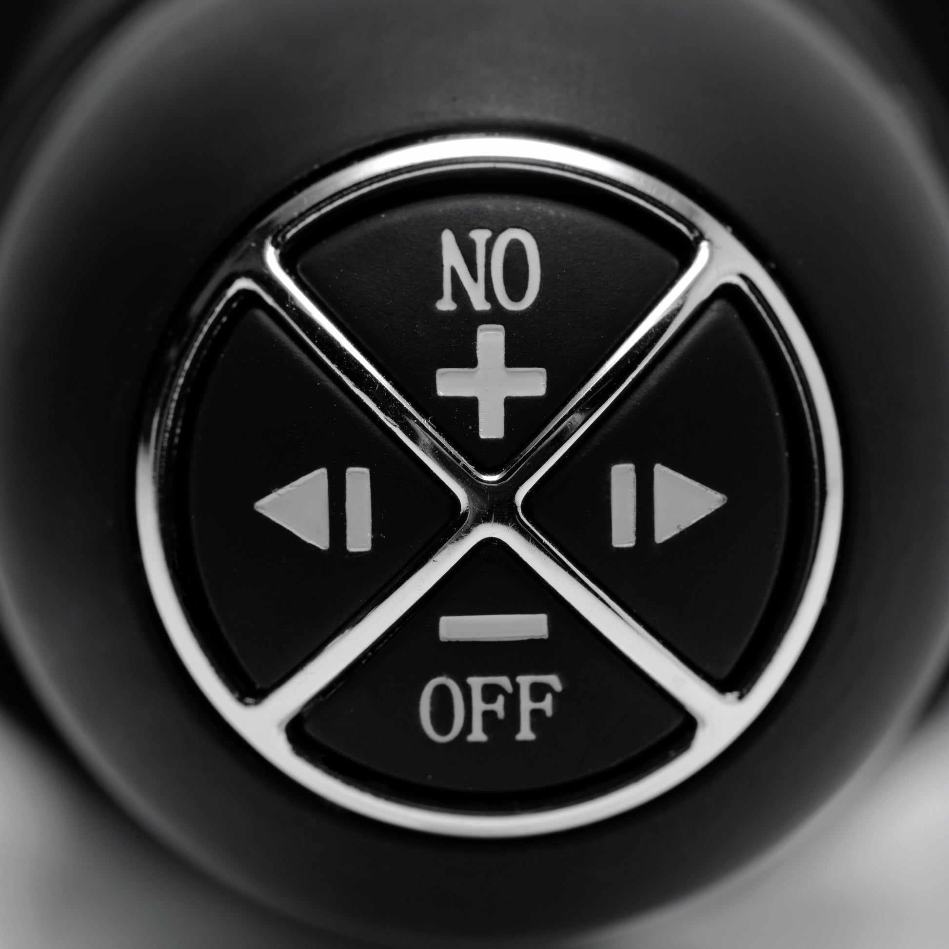 close up of Master Series Violator dildo thruster control buttons showing vibration and mode settings