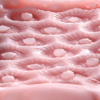 close up of masturbator sleeve interior showing raised bumps and textured stimulation pattern