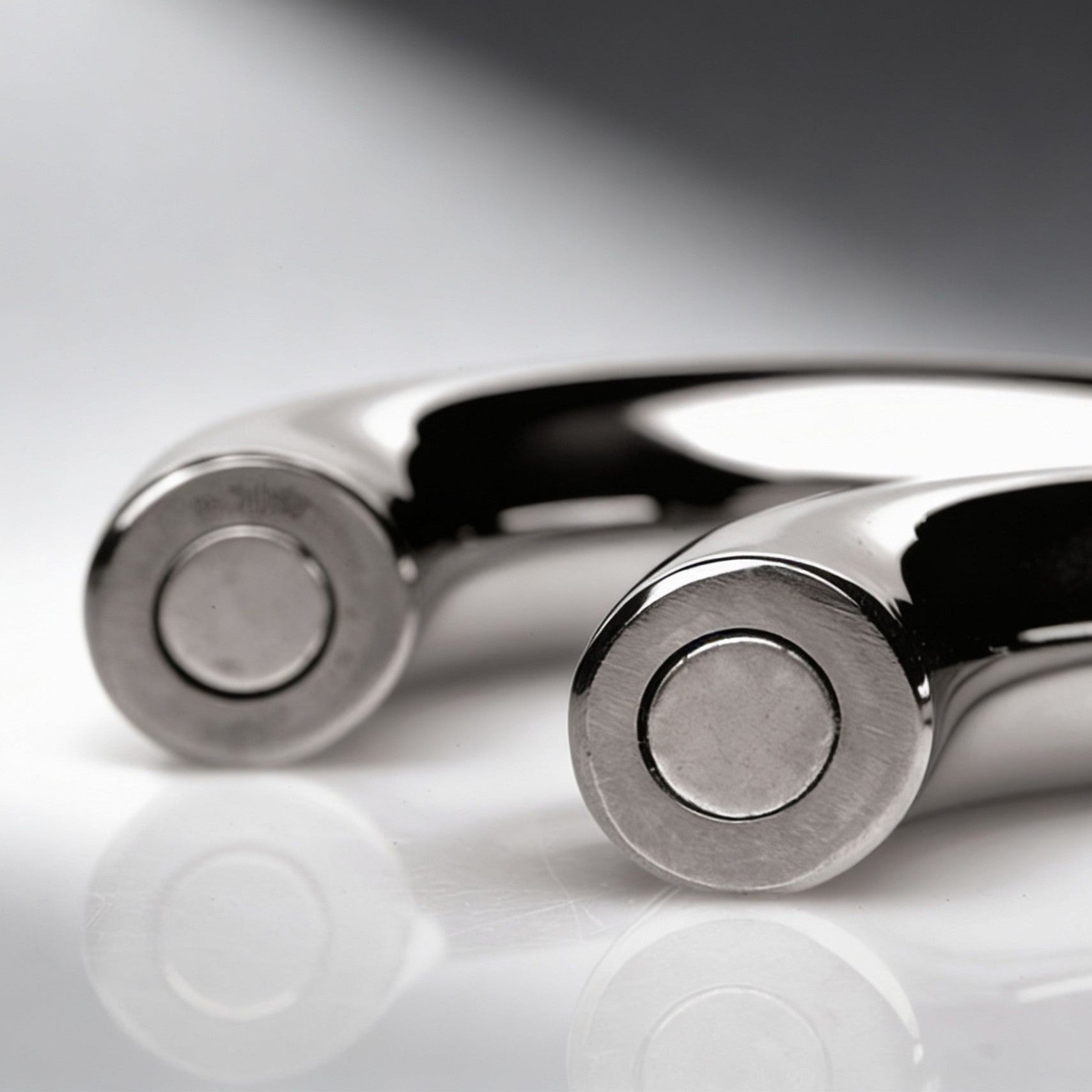 close up of magnetic connection ends on polished stainless steel cock ring halves