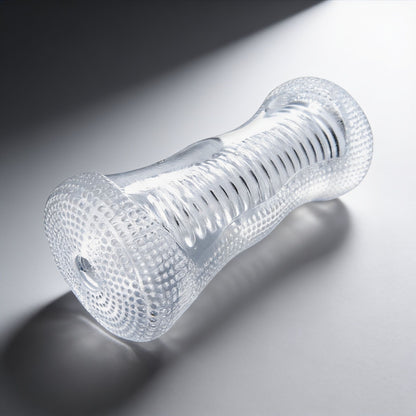 clear male stroker with a textured outer grip, transparent body, and ribbed internal tunnel displayed at an angled product view