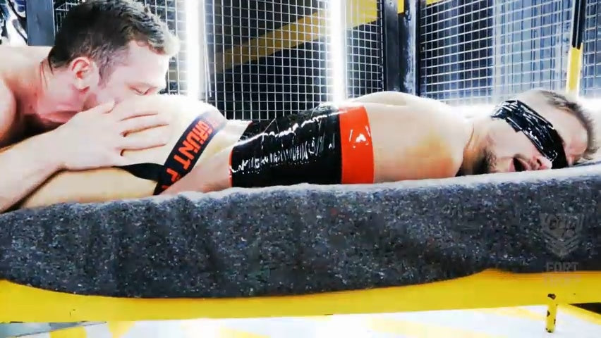 Mega-Roll Bondage Tape Red video, red self-stick tape wrapping a model in a bondage scene, Fort Troff gay gear at Boyzshop