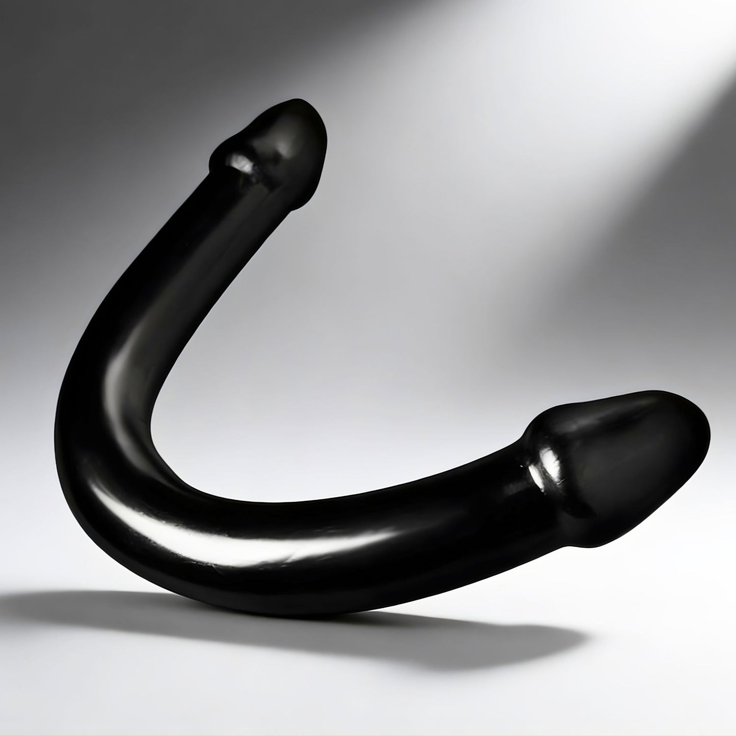 black XL double ended curved dildo with smooth finish and bulbous tips on neutral background