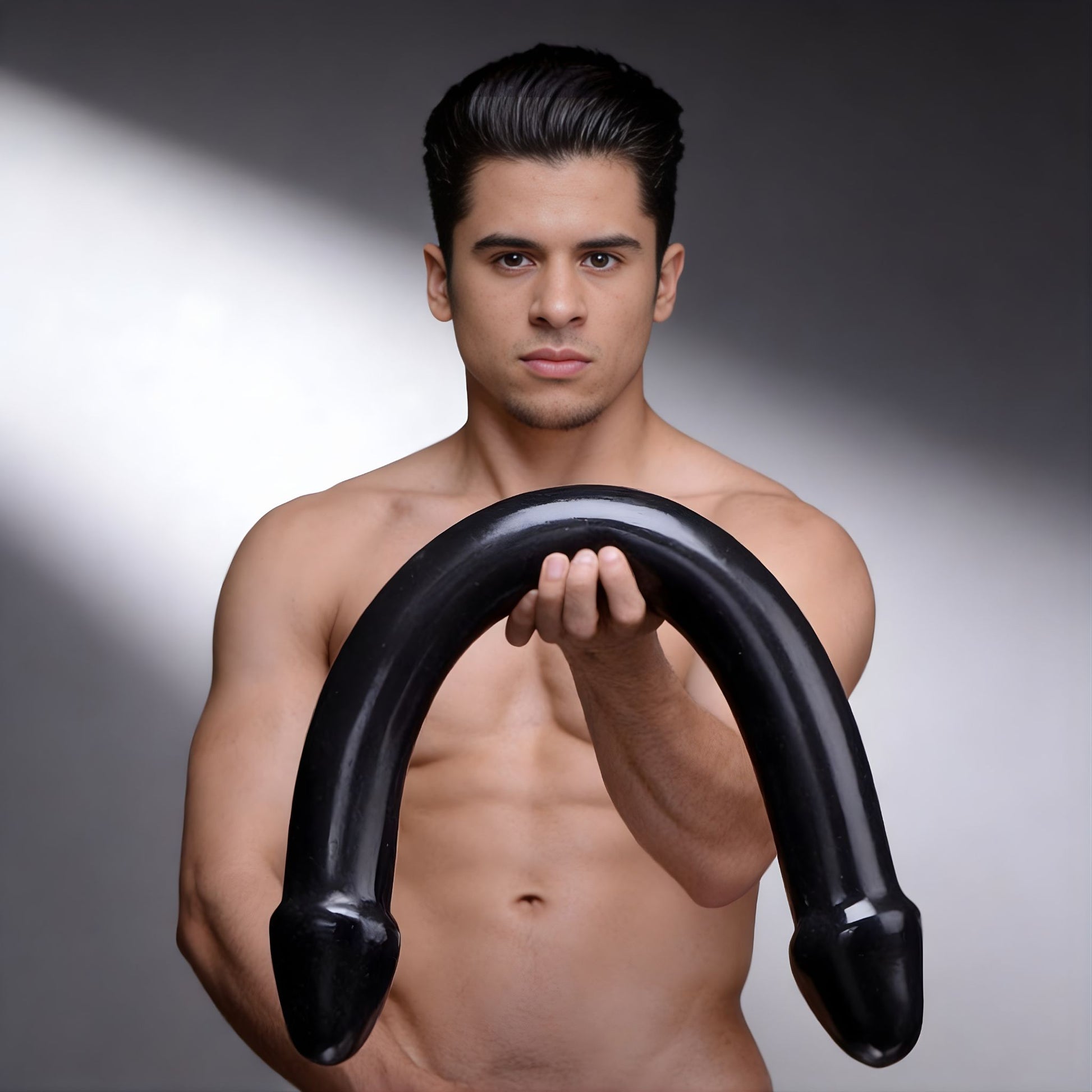 person holding large black double ended curved dildo to show size and flexible design