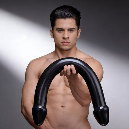 person holding large black double ended curved dildo to show size and flexible design