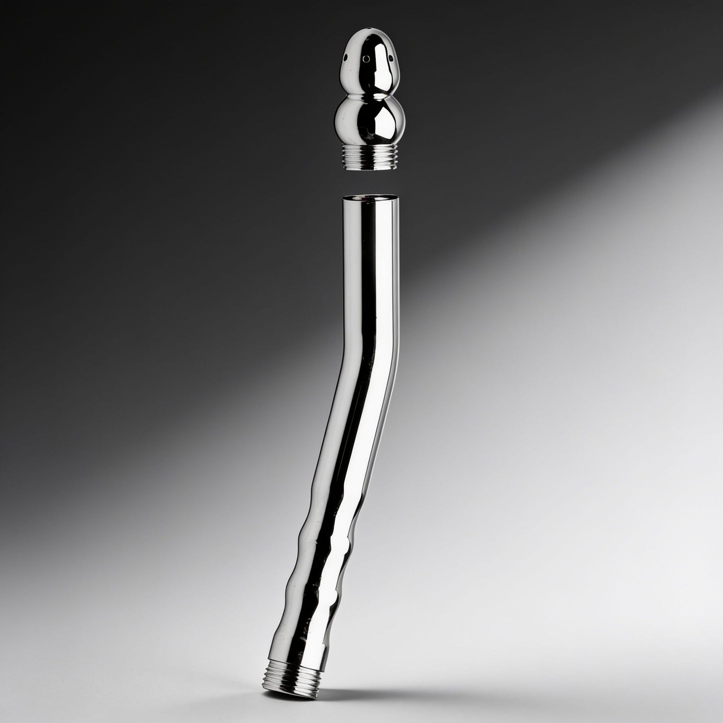 stainless steel angled shower enema wand with detachable spray tip shown separated from threaded handle body
