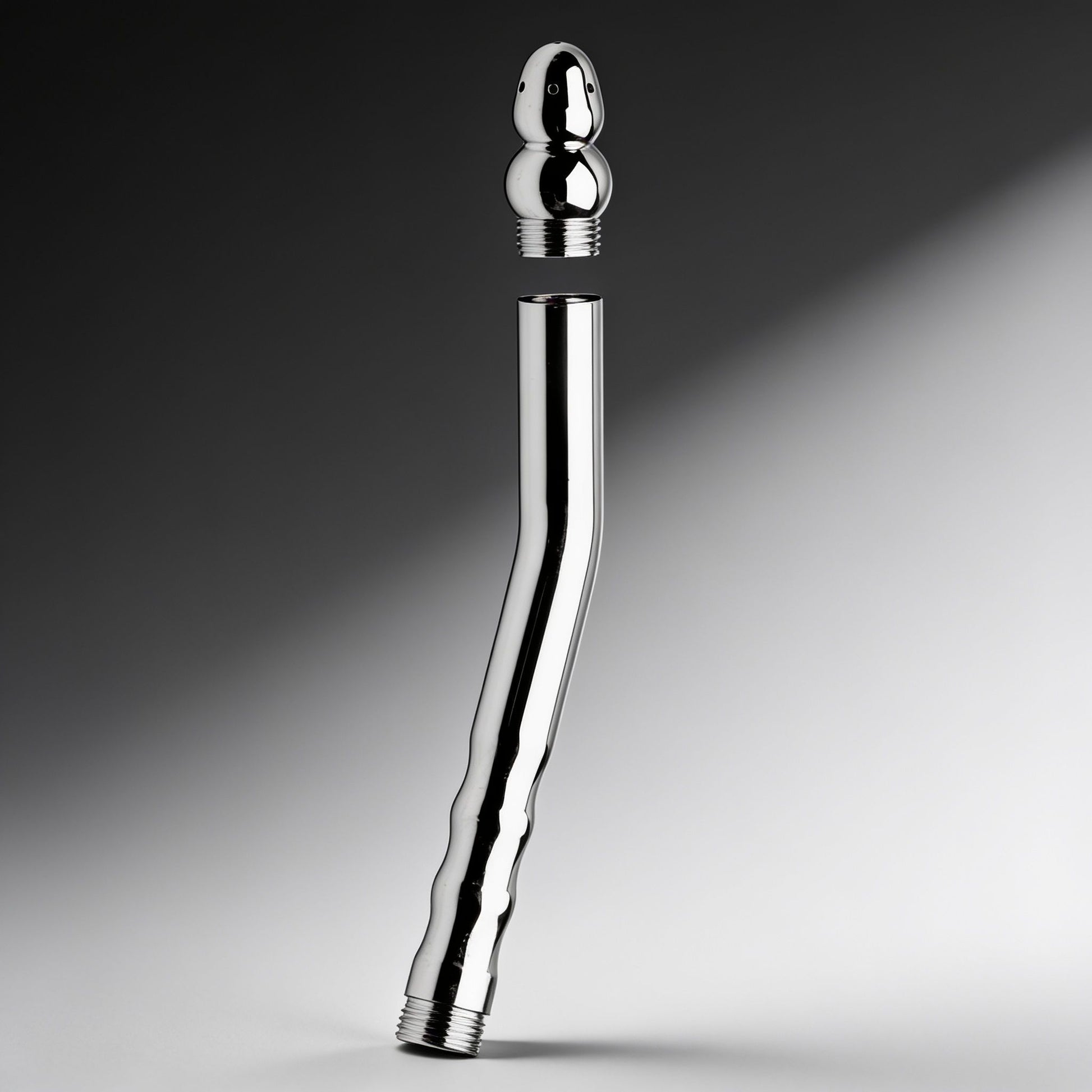 stainless steel angled shower enema wand with detachable spray tip shown separated from threaded handle body