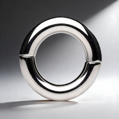 close up of polished stainless steel magnetic cock ring highlighting smooth circular shape and seamless join