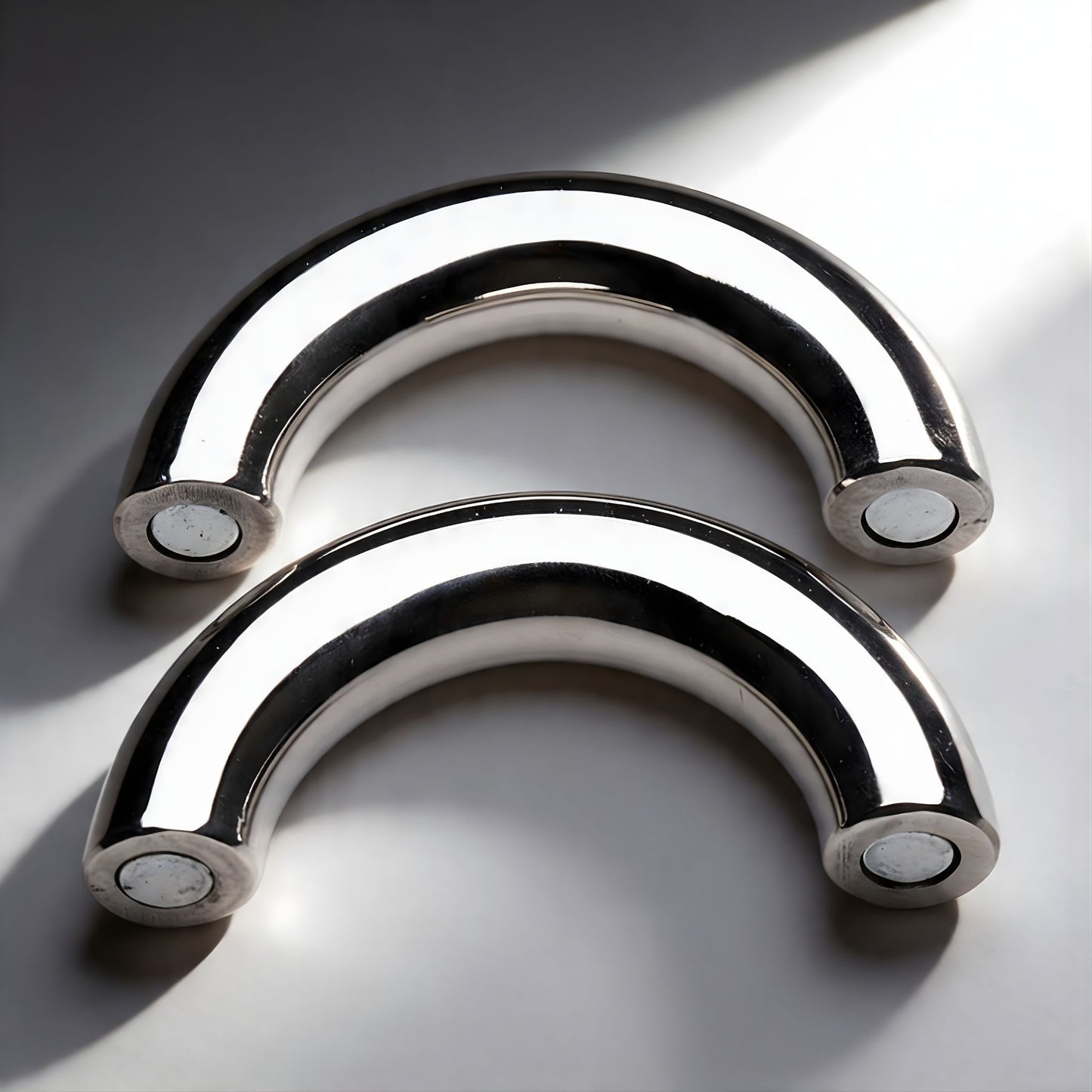 polished stainless steel magnetic cock ring with curved design two piece