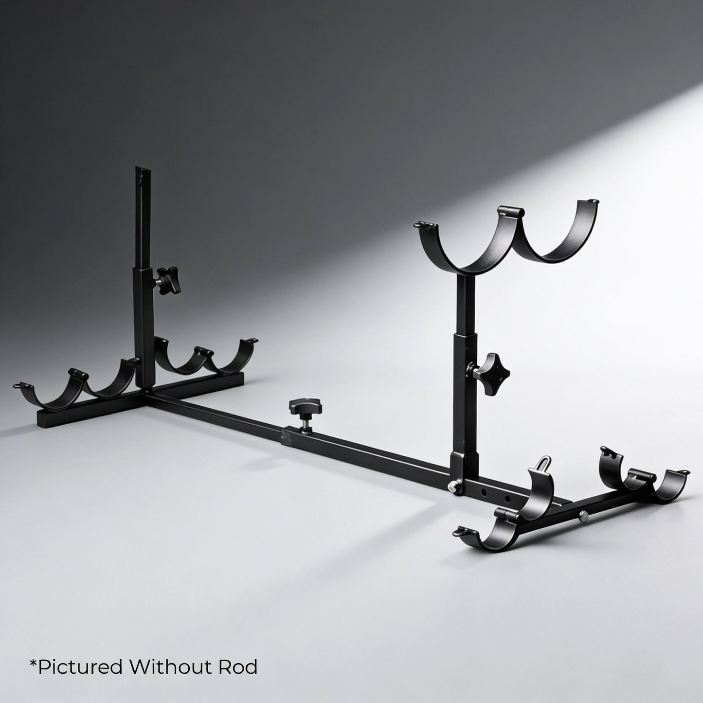 adjustable black metal stockade bondage frame with padded restraint cuffs and mounting brackets displayed without rod on gray background