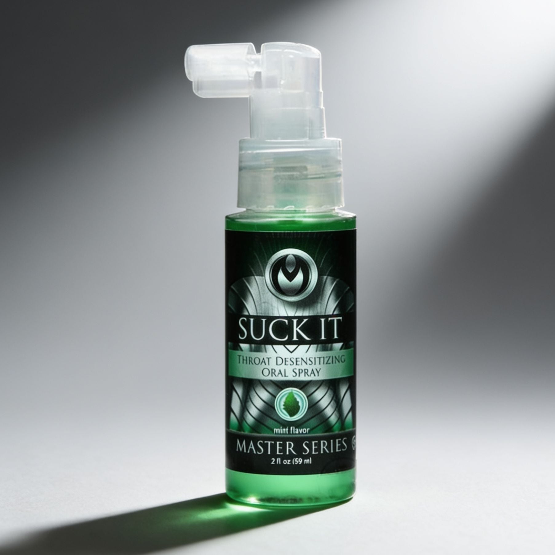 Suck It mint flavored throat desensitizing oral spray bottle standing upright with pump applicator in dramatic studio lighting