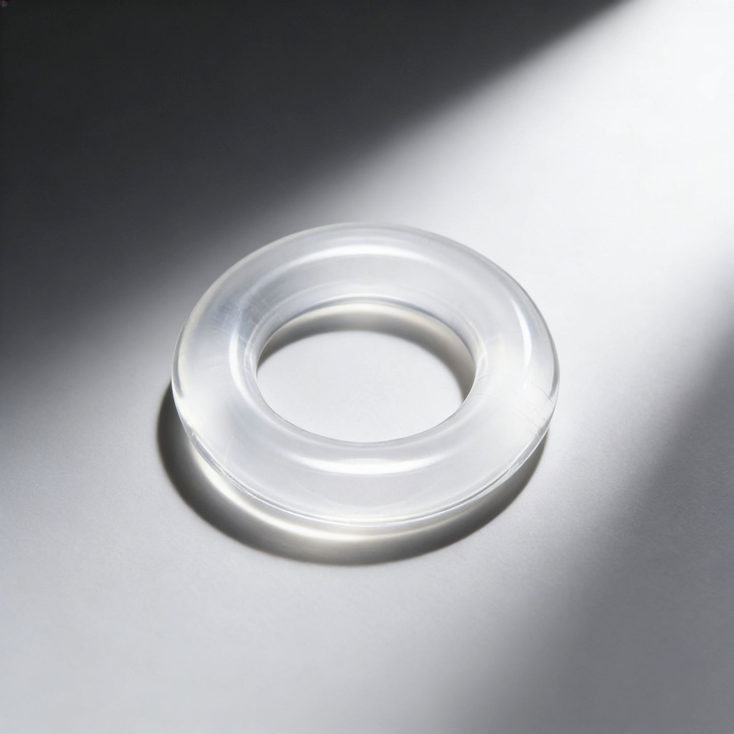angled product view of the Super Stretch Universal Cock Ring featuring a smooth transparent design and thick stretchy profile