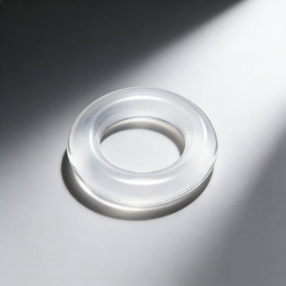 angled product view of the Super Stretch Universal Cock Ring featuring a smooth transparent design and thick stretchy profile