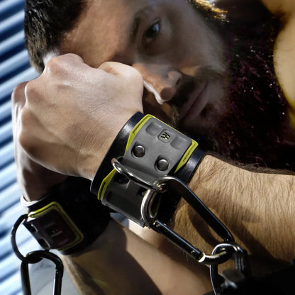 Tactical Wrist Cuff worn by a bearded model, black neoprene cuff with D-ring and carabiner, Fort Troff